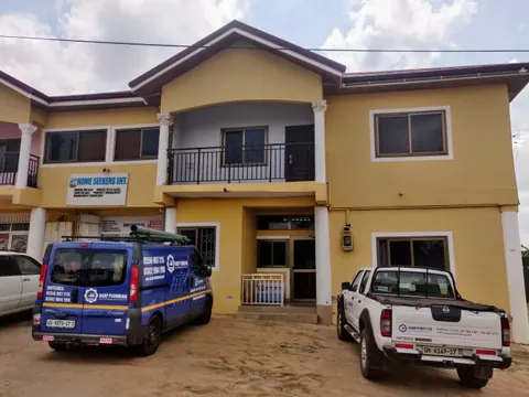 ASAP Plumbing van and pickup parked outside a two-storey commercial building