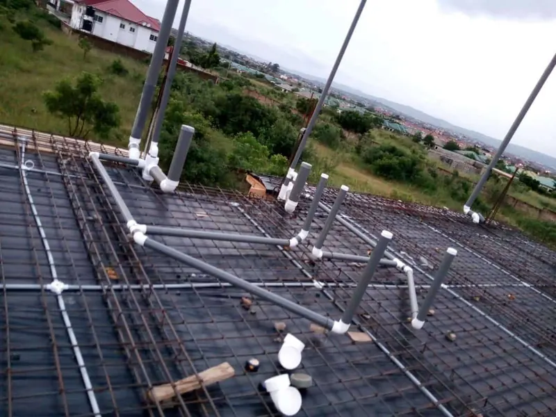 First-fix waste pipework laid across reinforced concrete slab formwork before pouring