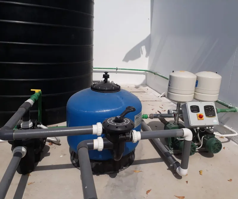 Water storage tank connected to a booster pump and filtration unit